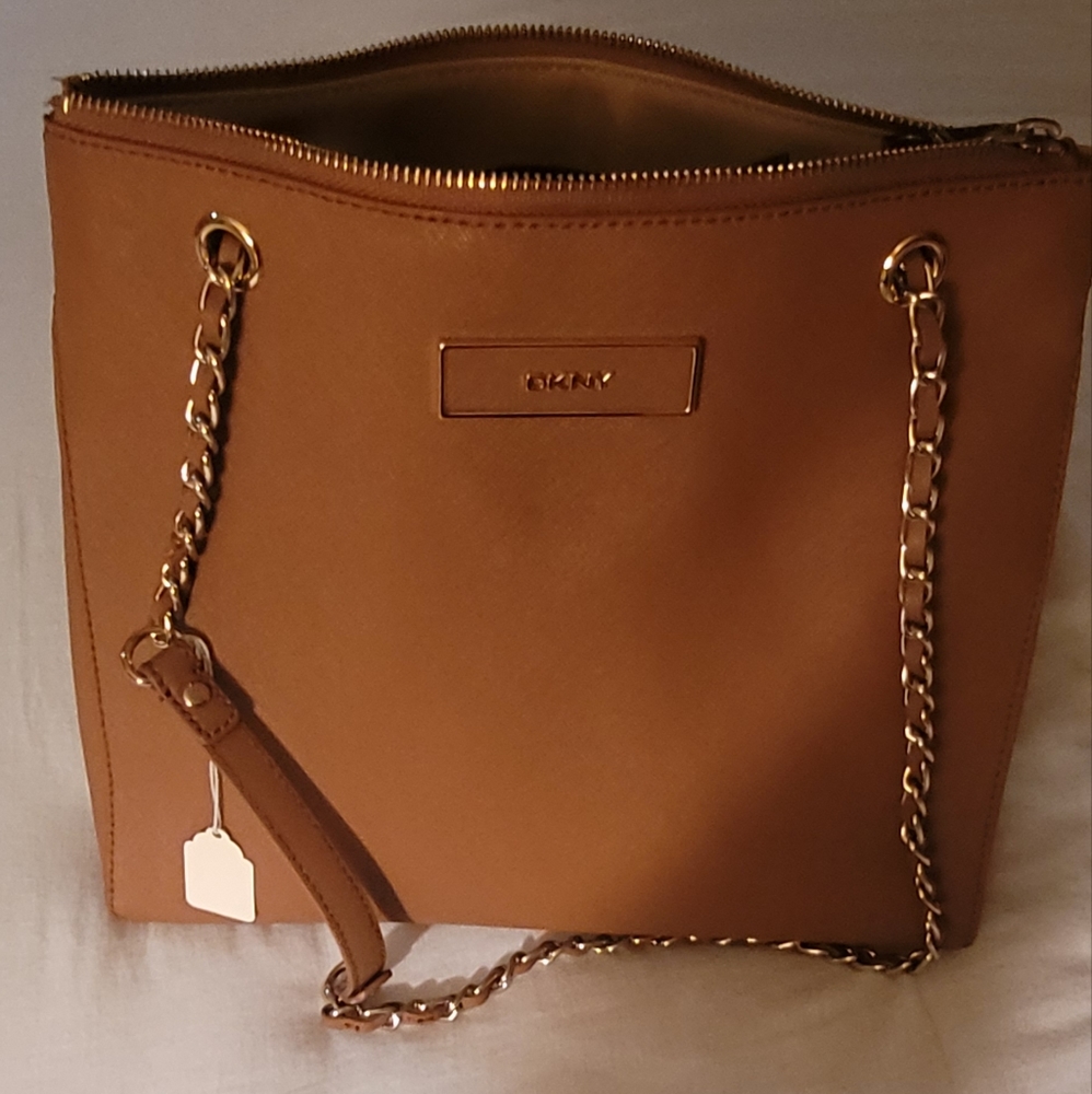 This is a DKNY bag tan color medium size